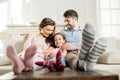 Daughter sitting with parents on sofa at home Royalty Free Stock Photo