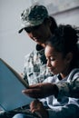 Daughter and soldier reading book Royalty Free Stock Photo