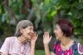 Daughter talking to hearing impaired elderly woman