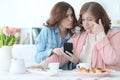 Daughter teaches an elderly mother to use a mobile phone