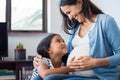 Daughter touching the belly of her pregnant mother Royalty Free Stock Photo