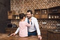 daughter tying up necktie for handsome happy father