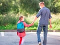 Daughter walking with father after school