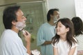 Daughter Watching Father Apply Shaving Cream In Bathroom