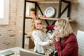 Irritated blonde businesswoman shutting mouth of her daughter Royalty Free Stock Photo