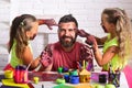 Daughters and dad smiling with painted hands