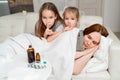 Daughters do not interfere with sick mother sleep. Royalty Free Stock Photo