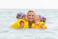 Daughters kiss mom swimming in sea Royalty Free Stock Photo