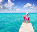 Daughters and mother in jetty on tropical beach Royalty Free Stock Photo