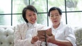 Daugther teaching mother to use smart phone for social media at