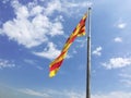 View flag catalana on background sky color blue and clouds gray