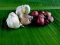 A two type spice red onion and garlic on the green banana leaf