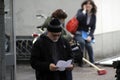 David Fincher standing in a street reading