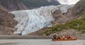 Tourists, a guide drifting in canoe by glacier Royalty Free Stock Photo