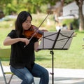 Violin student playing at Davis farmers market