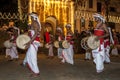 Davul Players (Davulkaruwo) perform past the Temple of the Sacred Tooth Relic complex in Kandy, Sri Lanka.
