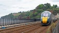 Passenger express train approaching Dawlish in Devon UK