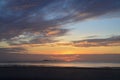 Dawn beauty, picturesque tropical orange coloured stratocumulus cloud coastal sunrise seascape in a blue sky Royalty Free Stock Photo