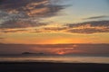 Dawn beauty, picturesque tropical orange coloured stratocumulus cloud coastal sunrise seascape in a blue sky Royalty Free Stock Photo