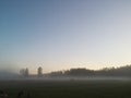 Dawn the beginning of a new day with a light morning fog on the field