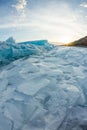 Dawn in the blue hummocks of ice lake baikal, in a snowy field i