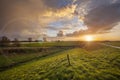 Dawn with cloudy sky over a rural river Maas