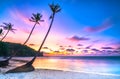 Dawn on a deserted beach with beautiful leaning coconut trees facing the sea Royalty Free Stock Photo