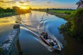 In the dawn , a fisherman going back home for his family . The boat is little bit blurry because of dark