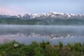 Dawn fog lake mountains flowers summer Royalty Free Stock Photo