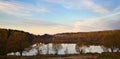 Dawn in the forest near the lake. The forest is reflected in the water. Autumn Early morning. Russia Royalty Free Stock Photo