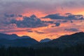 Dawn in the mountains. Colorful nature scenery with sunset or sunrise. Atmospheric landscape with silhouettes of mountains with