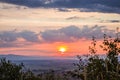 Dawn in the mountains. The sun rises from behind the mountains. Beautiful green hills and green valley. Little sleeping town. A Royalty Free Stock Photo