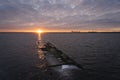 Dawn over the city of Tallinn as seen from the sea from the shore of Paljassaare. In the foreground there is a sunken tanker at Royalty Free Stock Photo