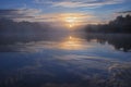 dawn over a foggy lake in the forest early in the morning. Royalty Free Stock Photo