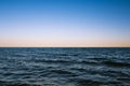 Dawn over the horizon of the dark ocean waters Royalty Free Stock Photo