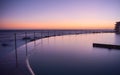 Dawn over an ocean pool and smooth glassy water