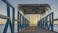 Dawn over the Red Sea. A wooden pedestrian walkway with metal railings goes over the water. Royalty Free Stock Photo