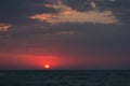 Dawn over the sea, the red sun rises above the horizon Royalty Free Stock Photo