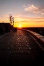 Dawn on the roof of a tall house. The sun rises on the horizon. Sunset, view from the roof. Foot prints on the black Royalty Free Stock Photo