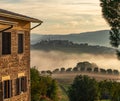 Dawn rural landscape with light fog. Italy sunrise panorama. country house