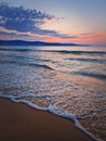 Dawn at the sea with foamy waves on the sand and colorful sky at the horizon. Sunny Beach coastline in Bulgaria. Summer and travel Royalty Free Stock Photo