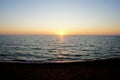 dawn at sea. sunset at sea. morning on the shore. sunrise. warm summer evening and the sea with light waves Royalty Free Stock Photo