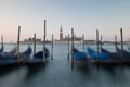 Dawn in Venice with gondolas and mooring posts Royalty Free Stock Photo