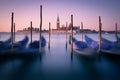 Dawn in Venice with gondolas and mooring posts Royalty Free Stock Photo