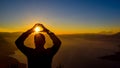 Dawn views of Lake Atitlan and hiker doing shapes from the heights of Indian Nose pointview