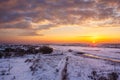 Dawn in the winter over the field in the snow Royalty Free Stock Photo