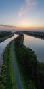 Dawn's First Light: A Riverside Pathway Reflecting the Morning Sky