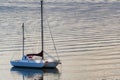 Dawns light reflect boat and rippled waters Royalty Free Stock Photo