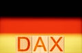 dax index concept. wooden blocks with the word dax on the background of the national flag of germany. Royalty Free Stock Photo
