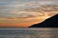 The sunset over a town on the Campania coast on the road to Amalfi.